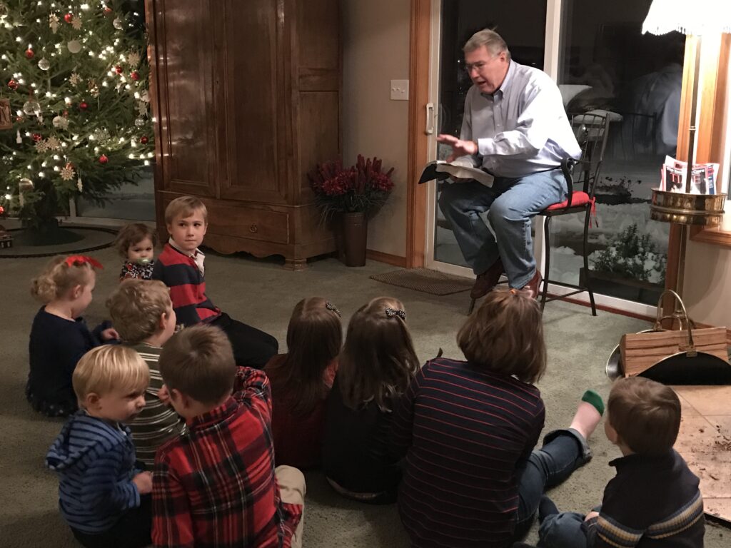 Francis Foucachon leading a Christmas reading for his grandchildren